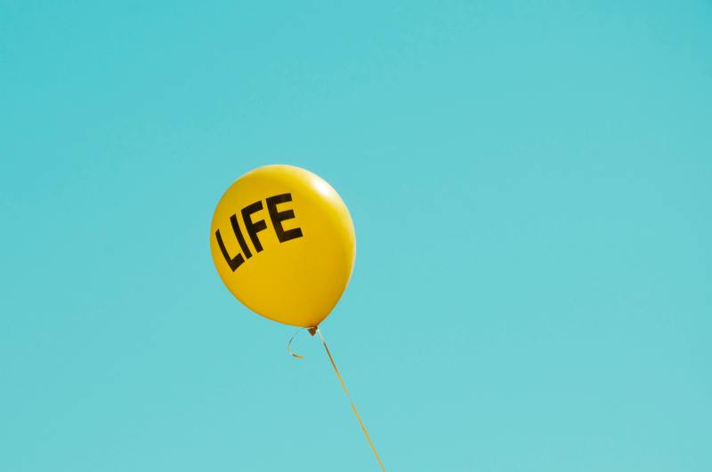 yellow 'Life' printed balloon